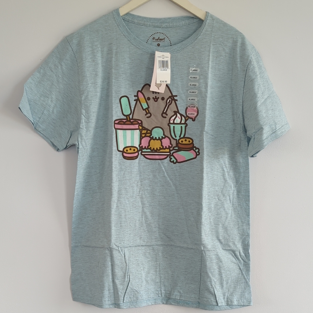 NWOT Pusheen Light Blue Short Sleeve Tee with Pastel Dessert Graphic.